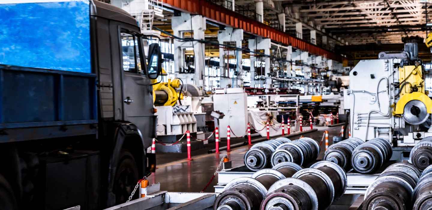 A vehicle is lifted on a hydraulic hoist inside a smooth and prepared vehicle repair shop.