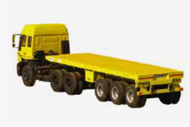 A long yellow Super Awan Transport flatbed trailer with safety equipment sits.